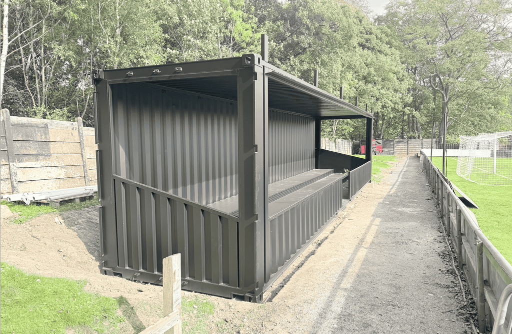 Side view of the shipping container spectator stand at Sheffield FC stadium.