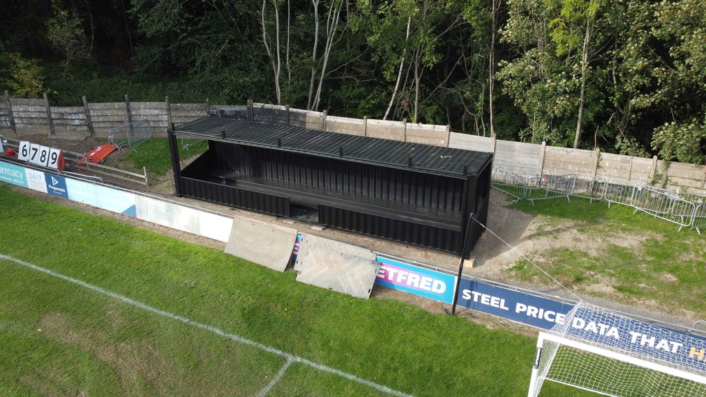 Aerial view of the shipping container spectator stand at Sheffield FC stadium.